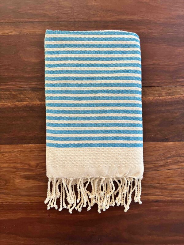 Folded beach towel on a wooden deck