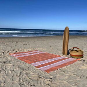 Extra large beach towel on a sandy beach