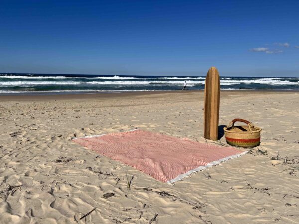 Extra large beach towel on a sandy beach