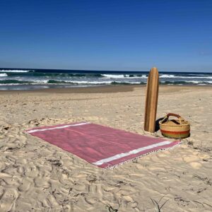 Extra large beach towel on a sandy beach