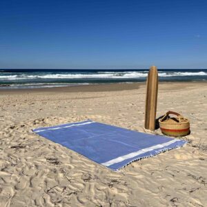 Extra large beach towel on a sandy beach