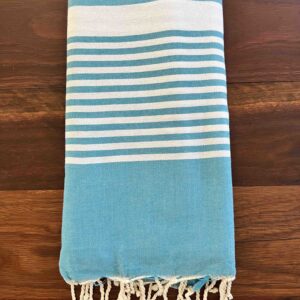 Folded beach towel on a wooden deck