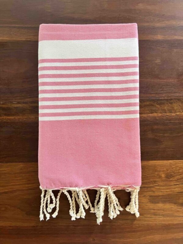 Folded beach towel on a wooden deck